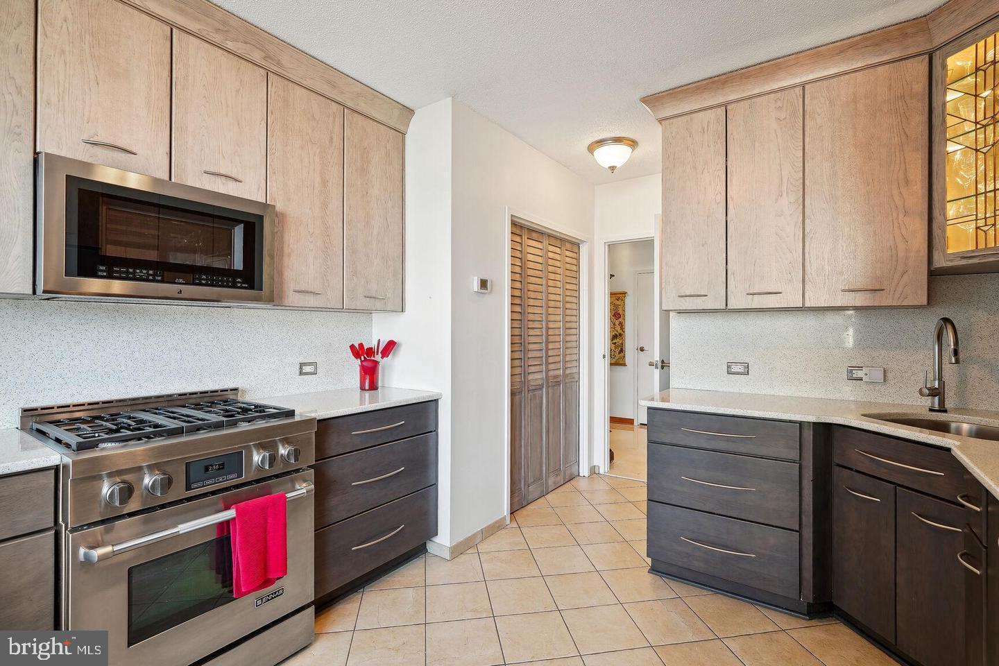 4141 North Henderson Road, Unit 611 Arlington, VA 22203 - Photo 8 of 30 a kitchen with stainless steel appliances granite countertop a stove a sink and a microwave