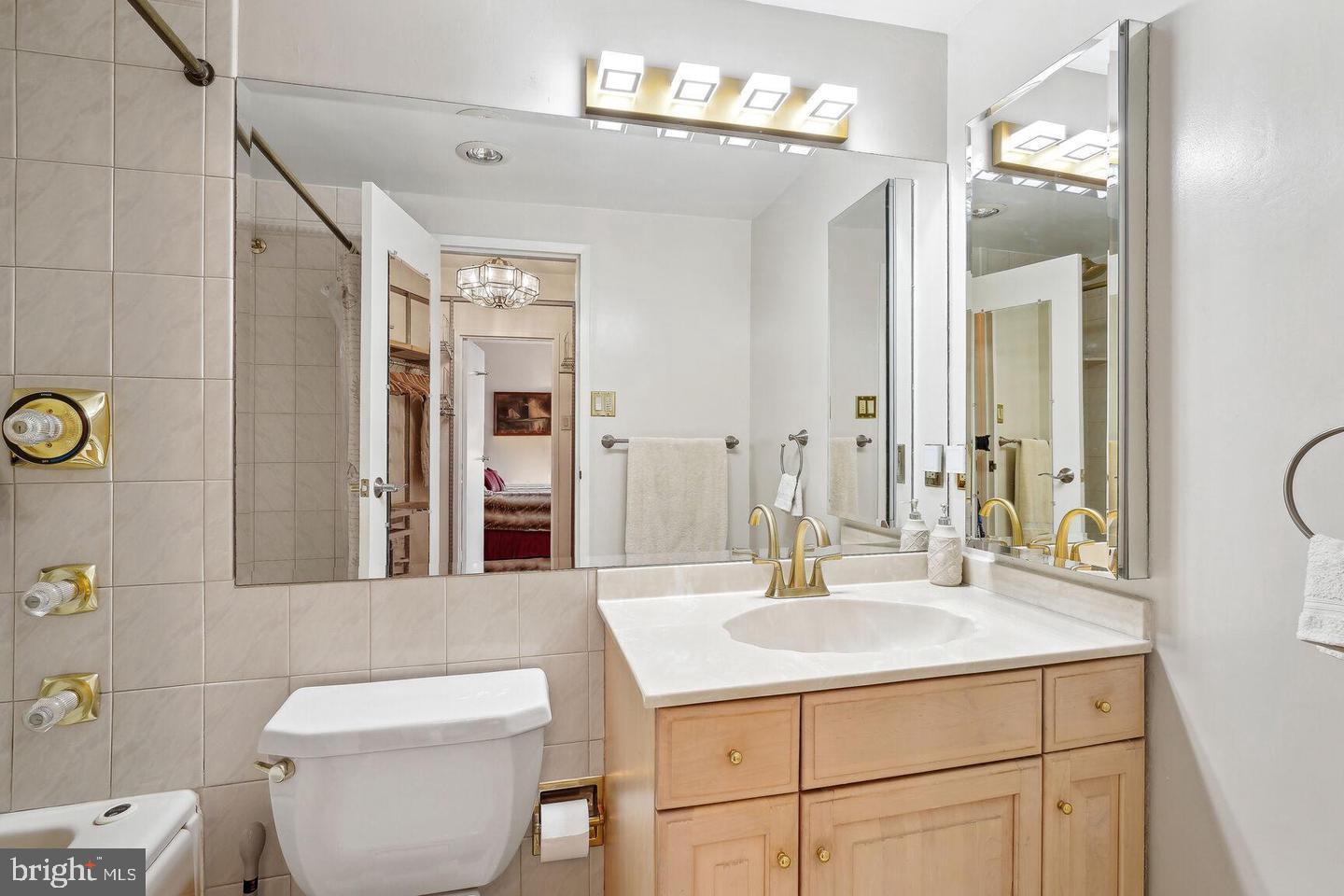 4141 North Henderson Road, Unit 611 Arlington, VA 22203 - Photo 10 of 30 a bathroom with a sink toilet and mirror