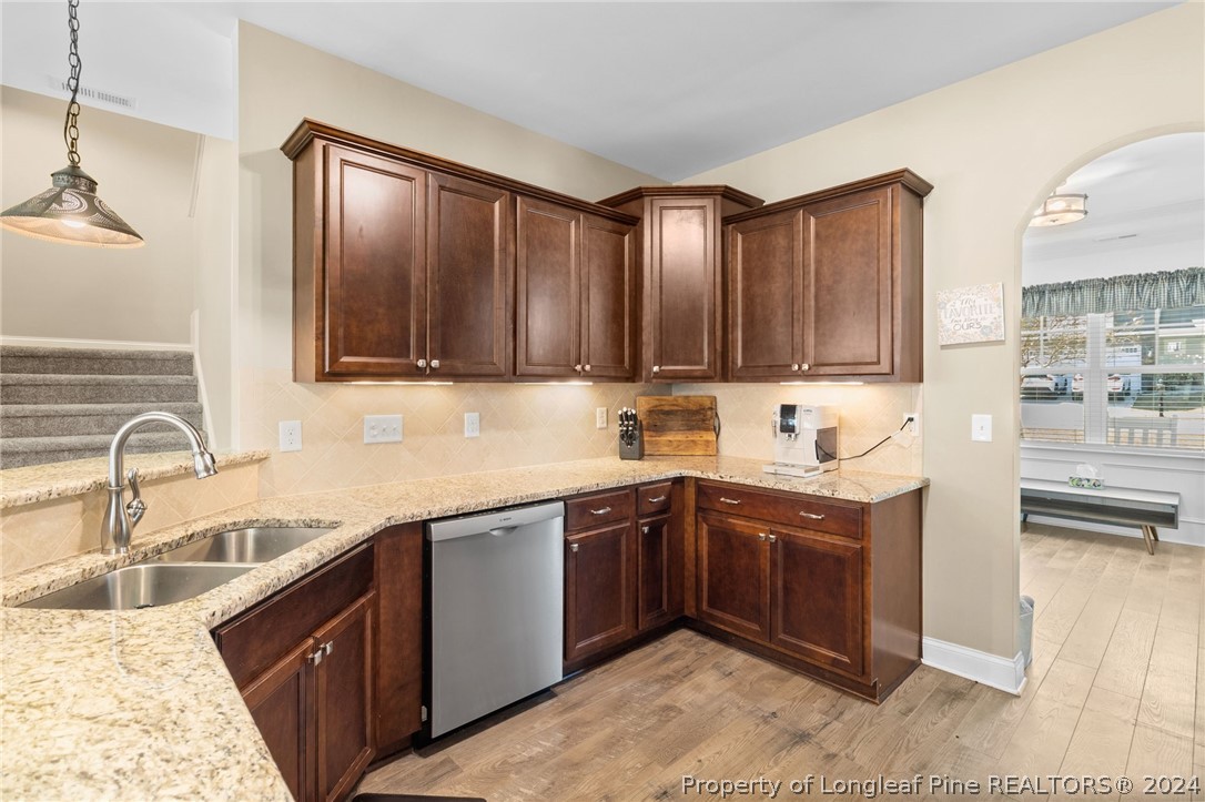 129 Warren Lake Road Aberdeen, NC 28315 - Photo 12 of 50 a kitchen with stainless steel appliances granite countertop a sink stove and cabinets