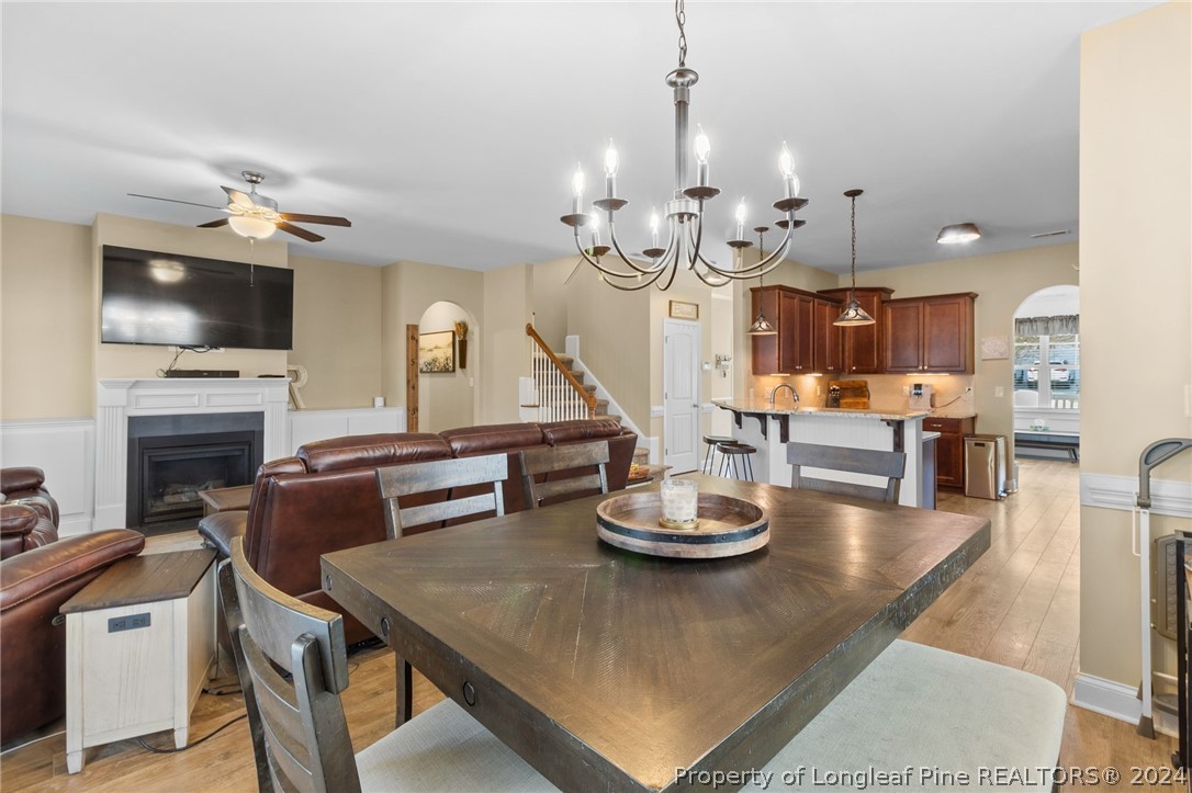 129 Warren Lake Road Aberdeen, NC 28315 - Photo 15 of 50 a view of a dining room with furniture a kitchen and chandelier
