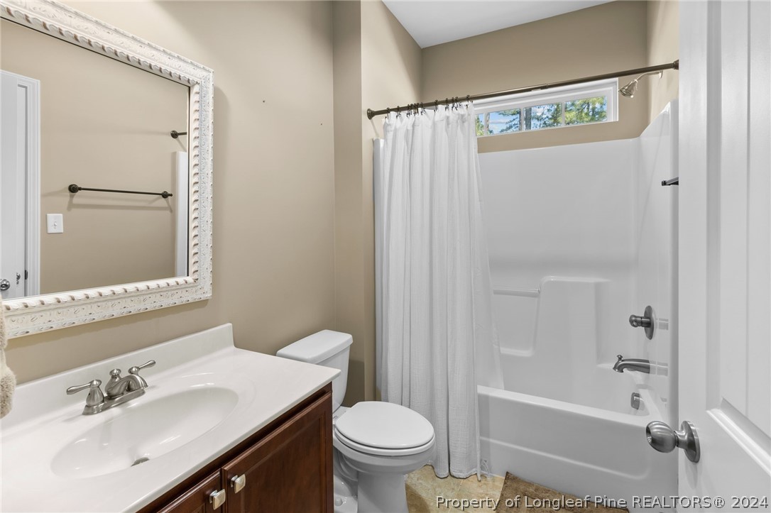 129 Warren Lake Road Aberdeen, NC 28315 - Photo 20 of 50 a bathroom with a sink a toilet and shower