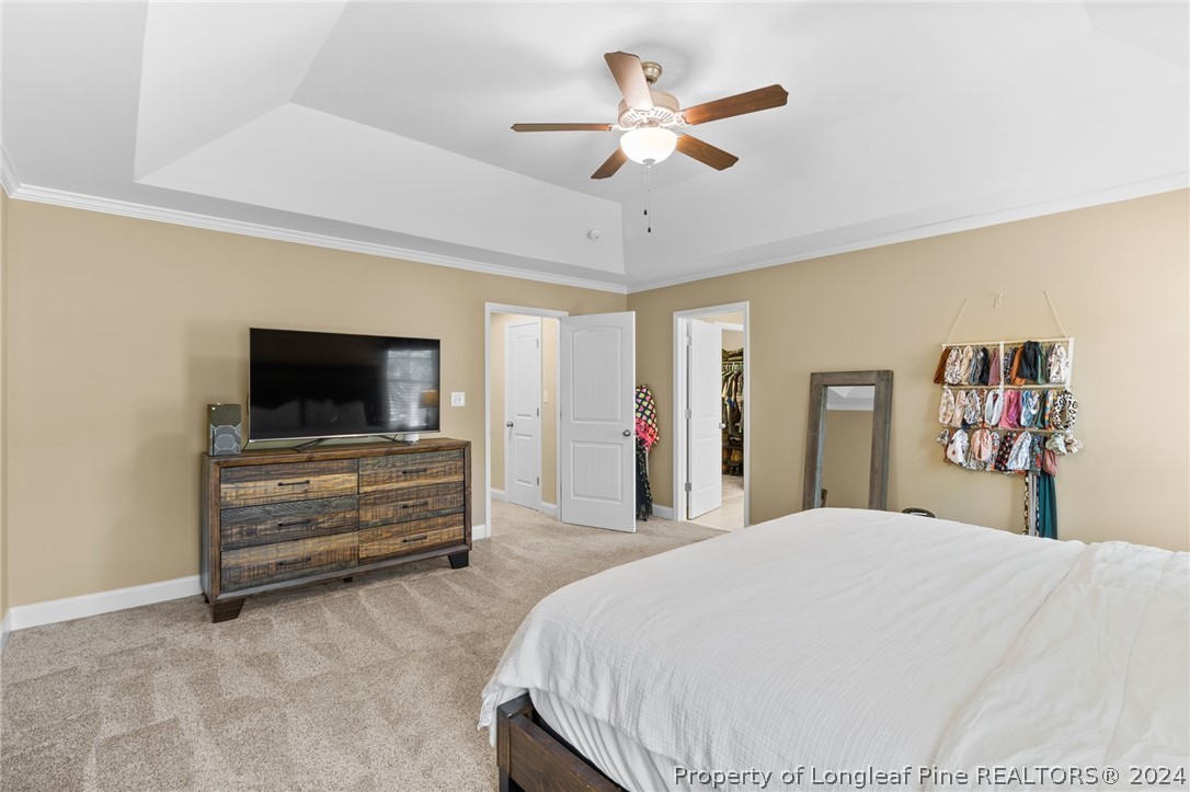 129 Warren Lake Road Aberdeen, NC 28315 - Photo 27 of 50 a bedroom with a bed and a flat screen tv