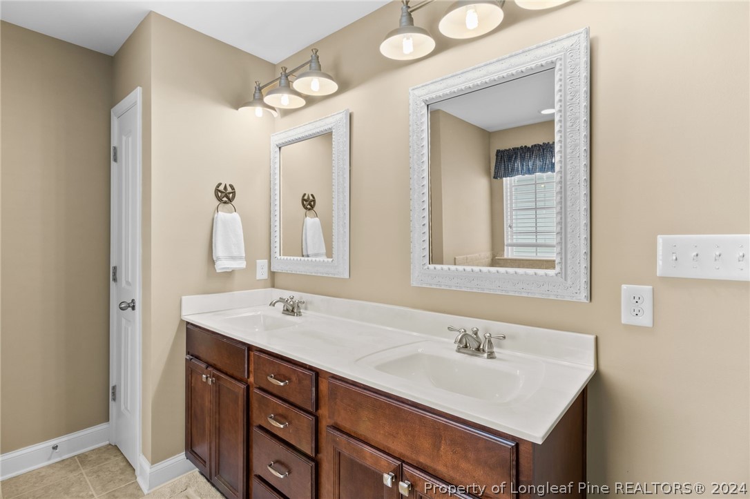 129 Warren Lake Road Aberdeen, NC 28315 - Photo 28 of 50 a bathroom with a sink and a mirror