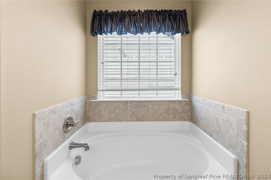 129 Warren Lake Road Aberdeen, NC 28315 - Photo 31 of 50 a bathroom with a bathtub and a window