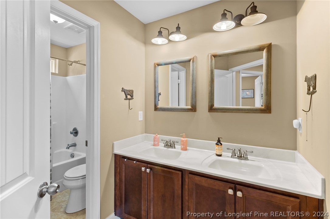 129 Warren Lake Road Aberdeen, NC 28315 - Photo 33 of 50 a bathroom with a double vanity sink toilet and shower