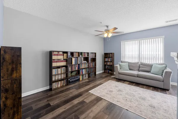 a living room with furniture a flat screen tv and a window