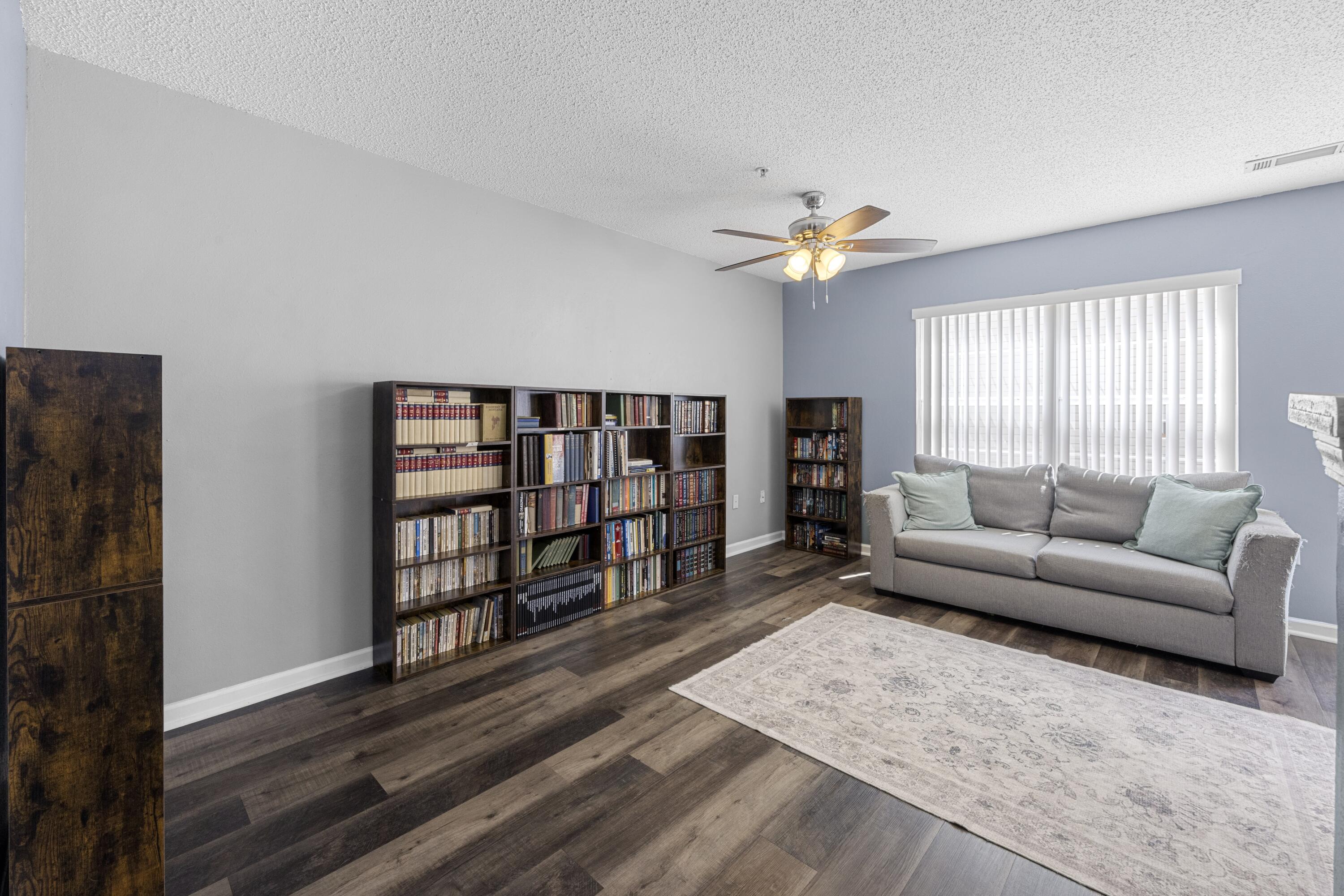 313 Crooked Pine Trail Crestview, FL 32539 - Photo 13 of 43 a living room with furniture a flat screen tv and a window