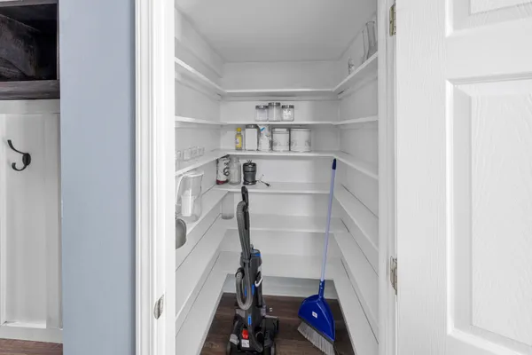 a view of walk in closet with empty racks