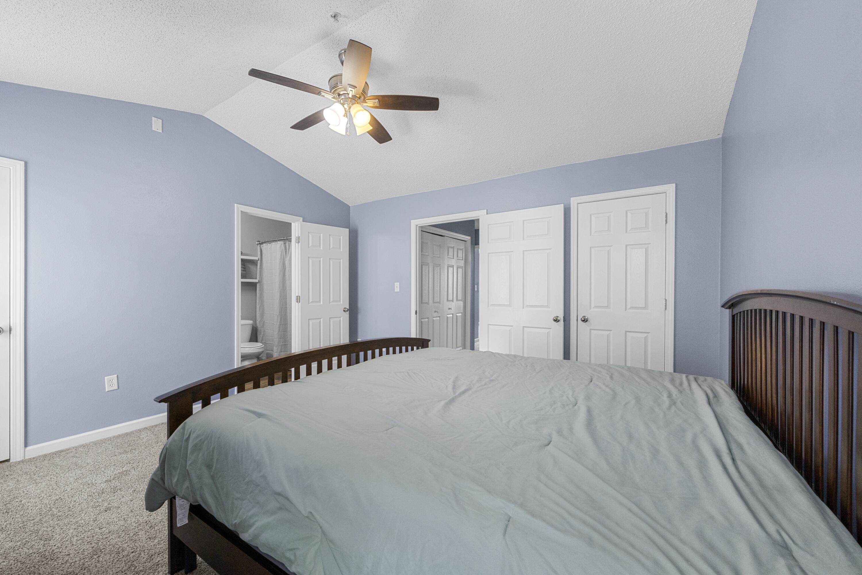 313 Crooked Pine Trail Crestview, FL 32539 - Photo 21 of 43 a bedroom with a bed and a chandelier