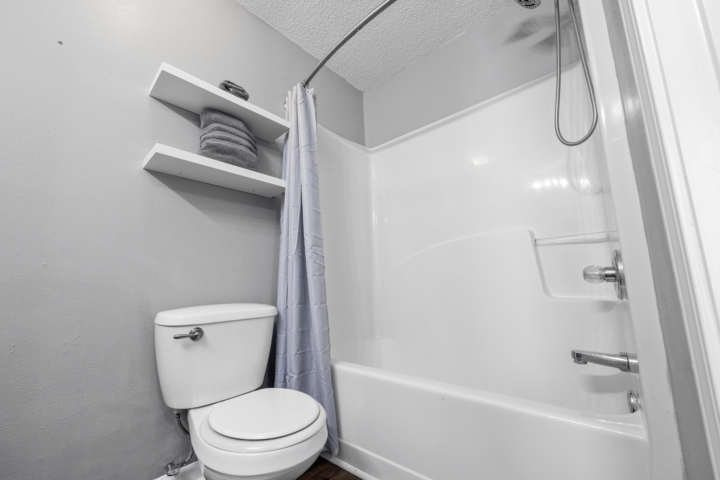 313 Crooked Pine Trail Crestview, FL 32539 - Photo 23 of 43 a white toilet sitting next to a bath tub