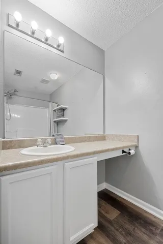 a view of a hallway with wooden floor and entryway