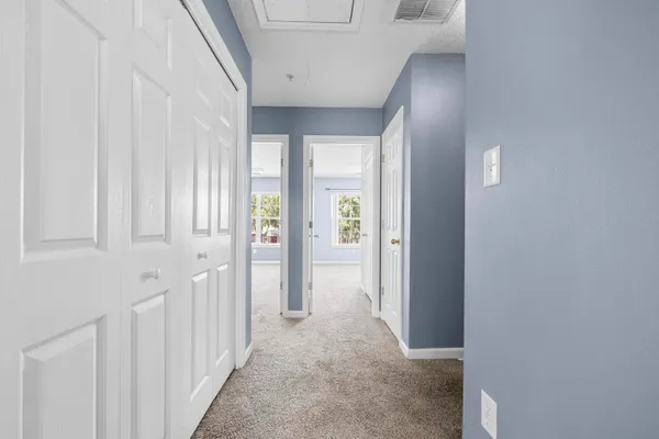 an empty room with window and ceiling fan