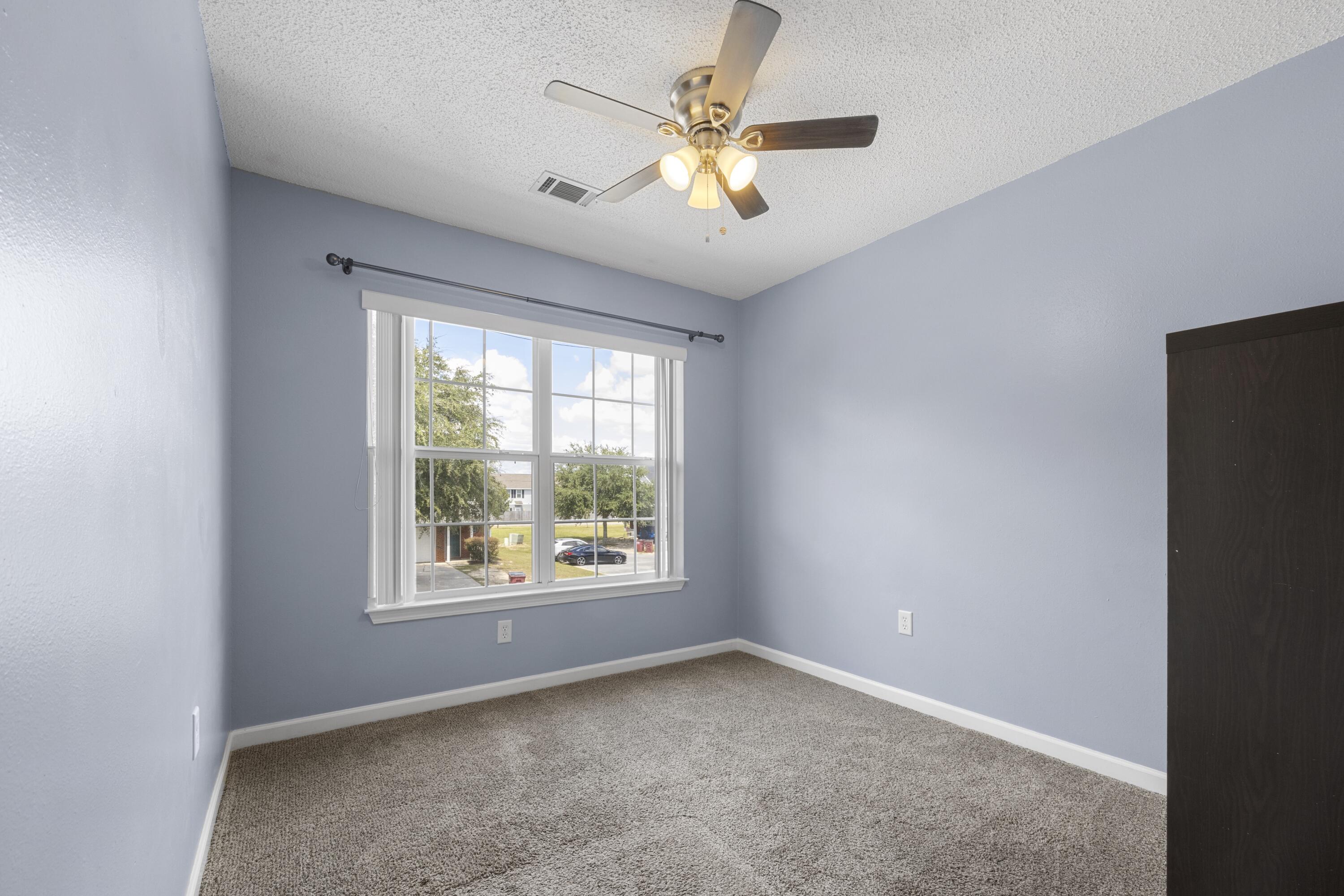 313 Crooked Pine Trail Crestview, FL 32539 - Photo 29 of 43 an empty room with a window and a fan
