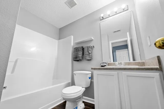 a bathroom with a bathtub and a toilet