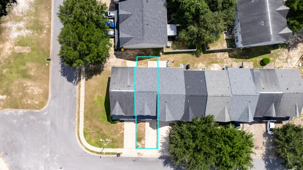 an aerial view of a house with a yard