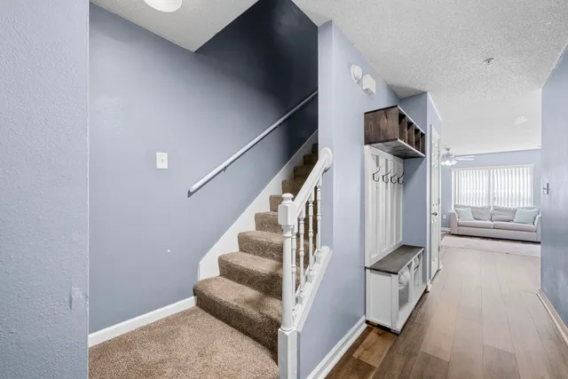 a view of entryway and hall with wooden floor