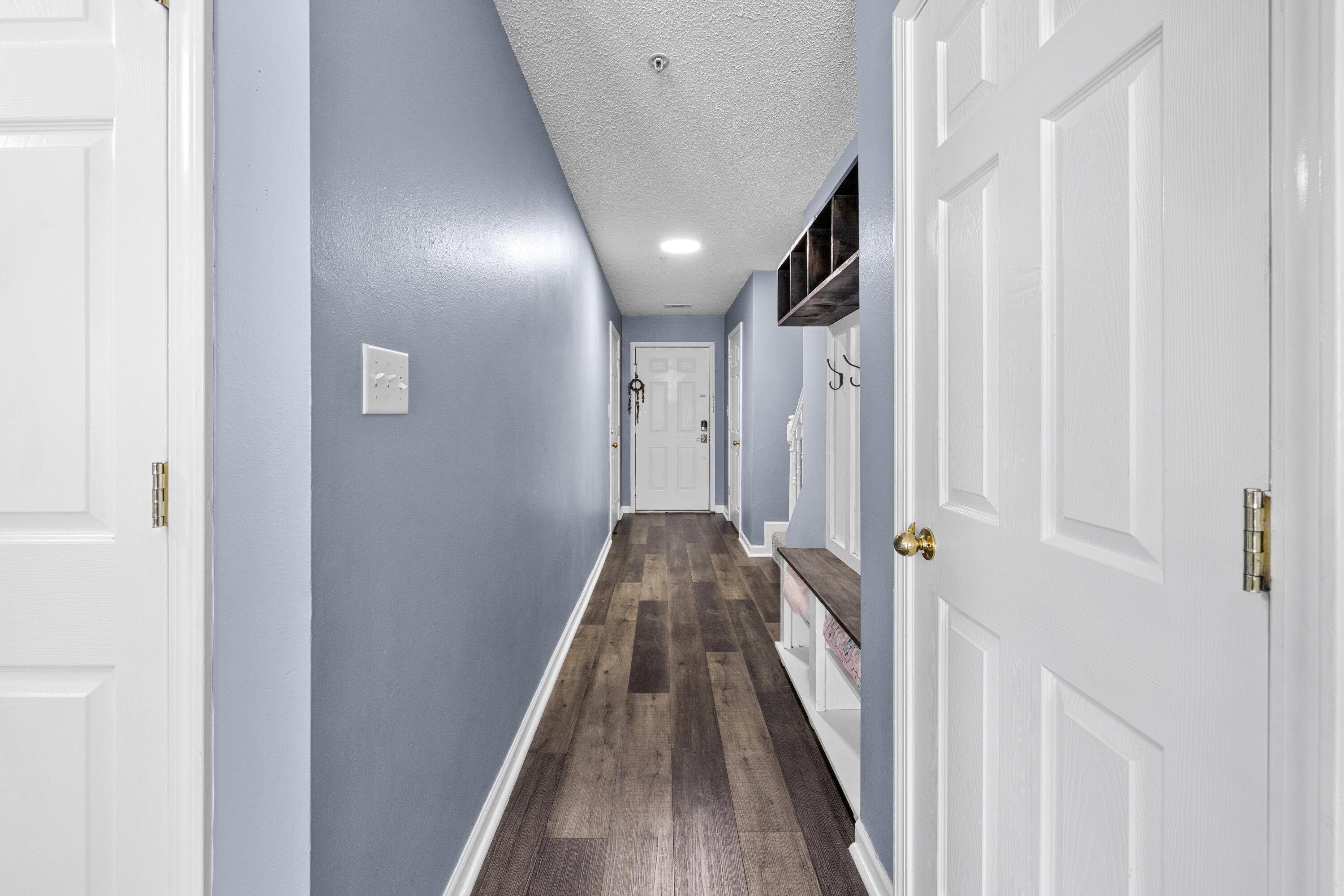 313 Crooked Pine Trail Crestview, FL 32539 - Photo 5 of 43 a view of a hallway with wooden floor and staircase