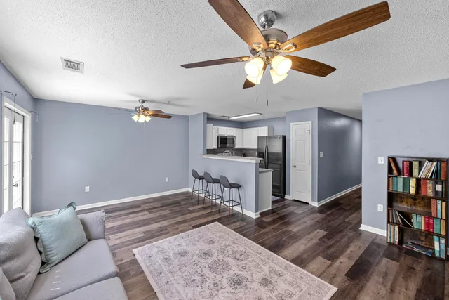 a living room with furniture and a book shelf