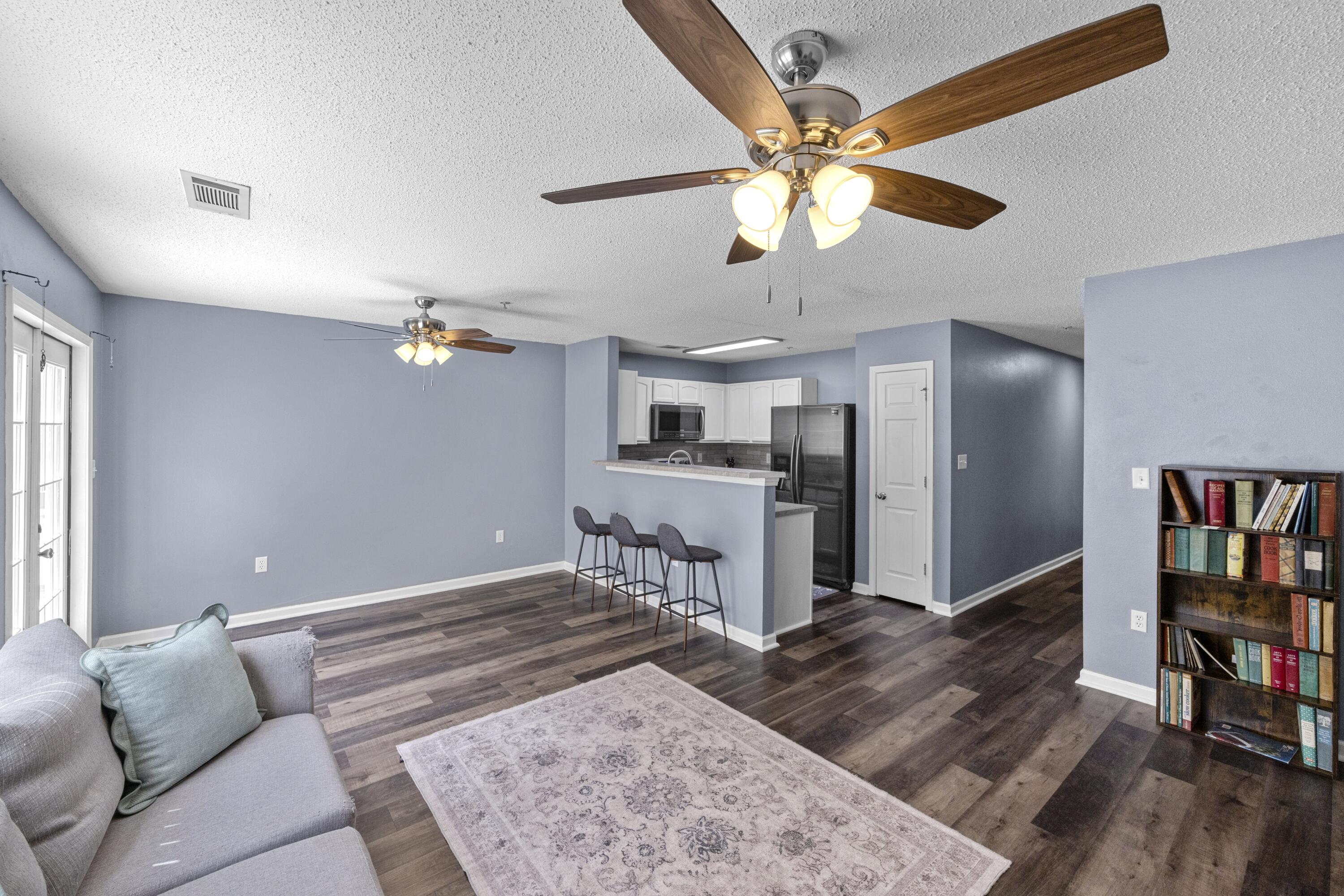 313 Crooked Pine Trail Crestview, FL 32539 - Photo 7 of 43 a living room with furniture and a book shelf