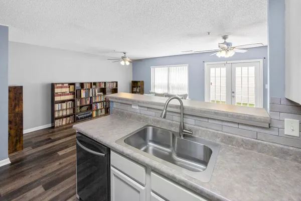a kitchen with a sink and chandelier