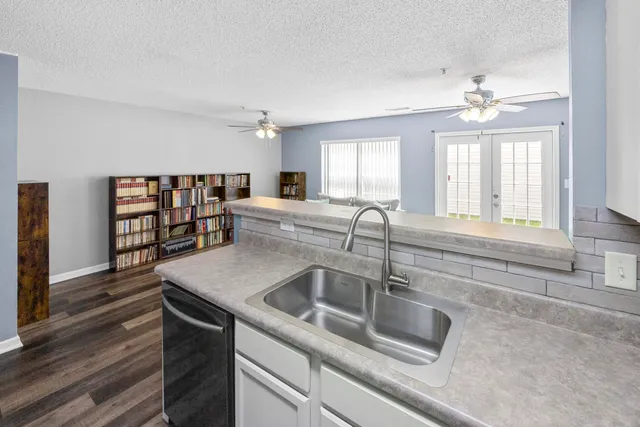 a kitchen with a sink and chandelier