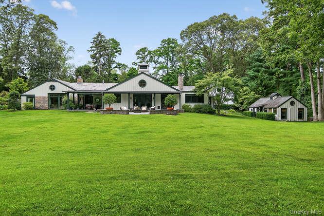 343 Chicken Valley Road Glen Head, NY 11545 - Photo 42 of 49 a white house with a big yard and large trees