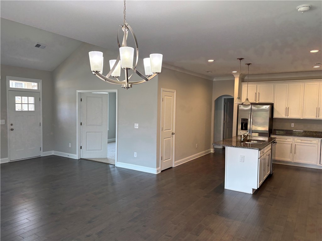 240 Meridian Way Seneca, SC 29672 - Photo 19 of 19 An open floorplan seamlessly connects the kitchen with granite counters to the living area with dark hardwood floors.