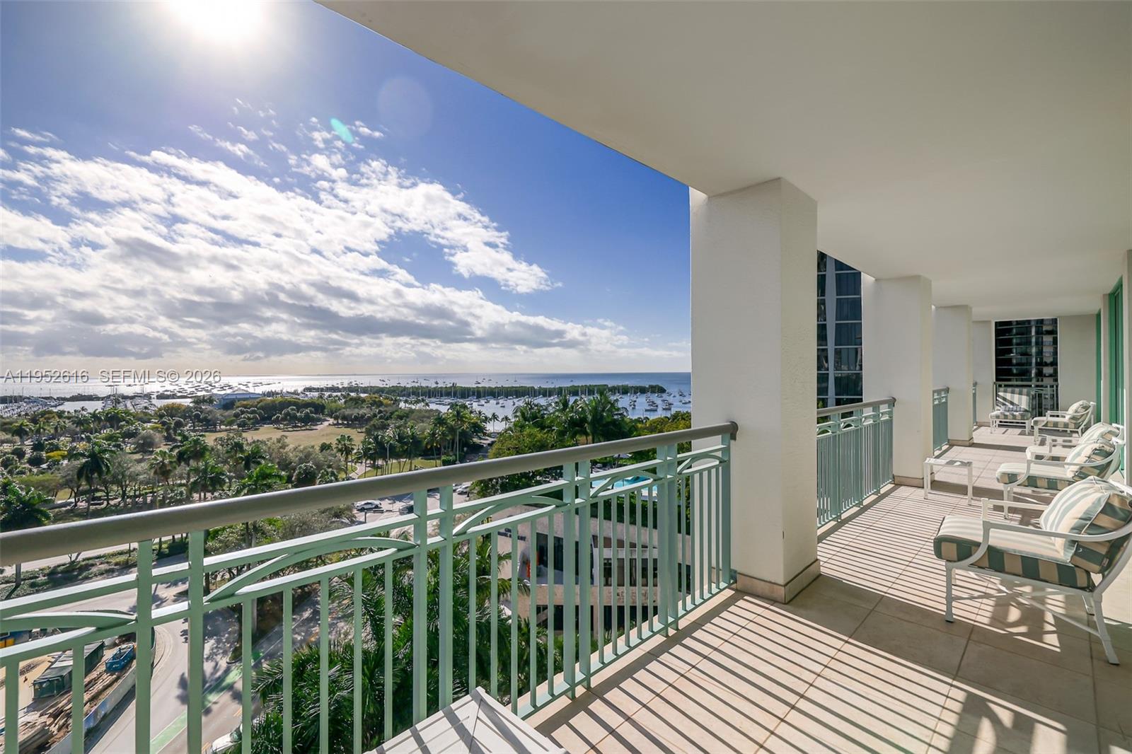 3400 Southwest 27th Avenue, Unit 802 Miami, FL 33133 - Photo 14 of 19 a view of a balcony with mountain view and wooden floor