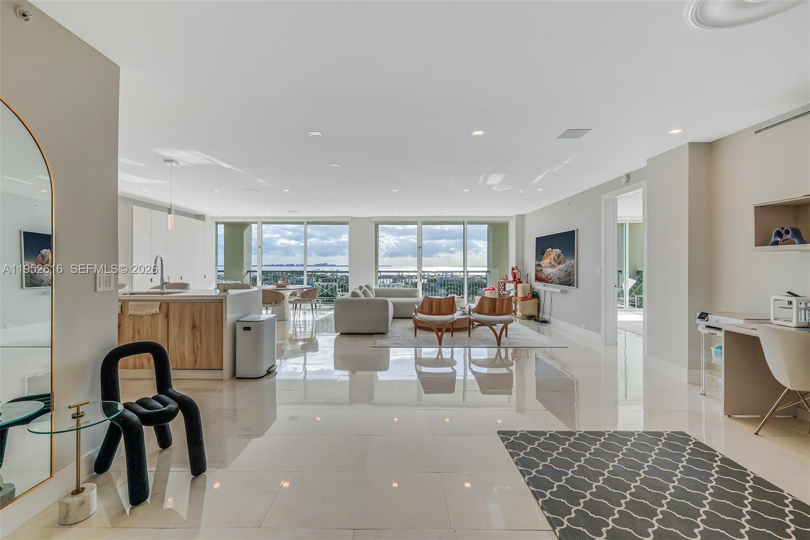 3400 Southwest 27th Avenue, Unit 802 Miami, FL 33133 - Photo 2 of 19 a living room with lots of furniture and a rug