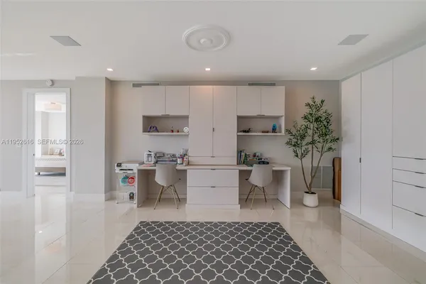 a kitchen with a sink and white cabinets