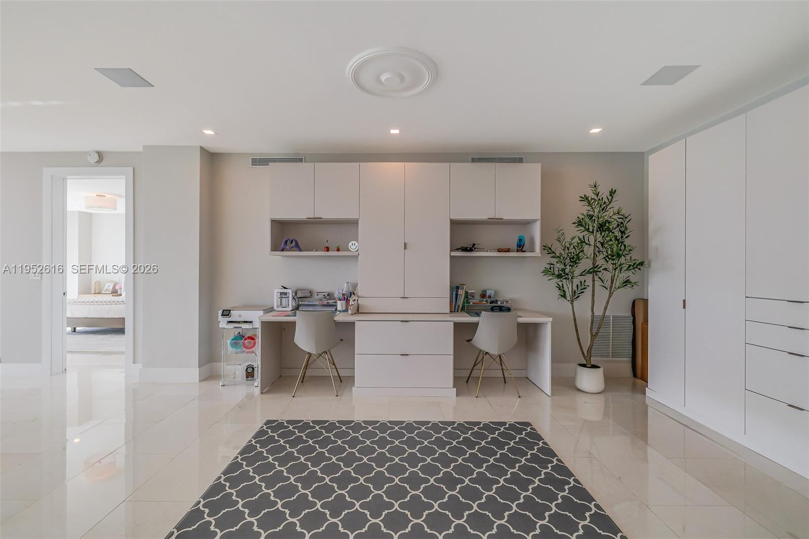 3400 Southwest 27th Avenue, Unit 802 Miami, FL 33133 - Photo 3 of 19 a kitchen with a sink and white cabinets