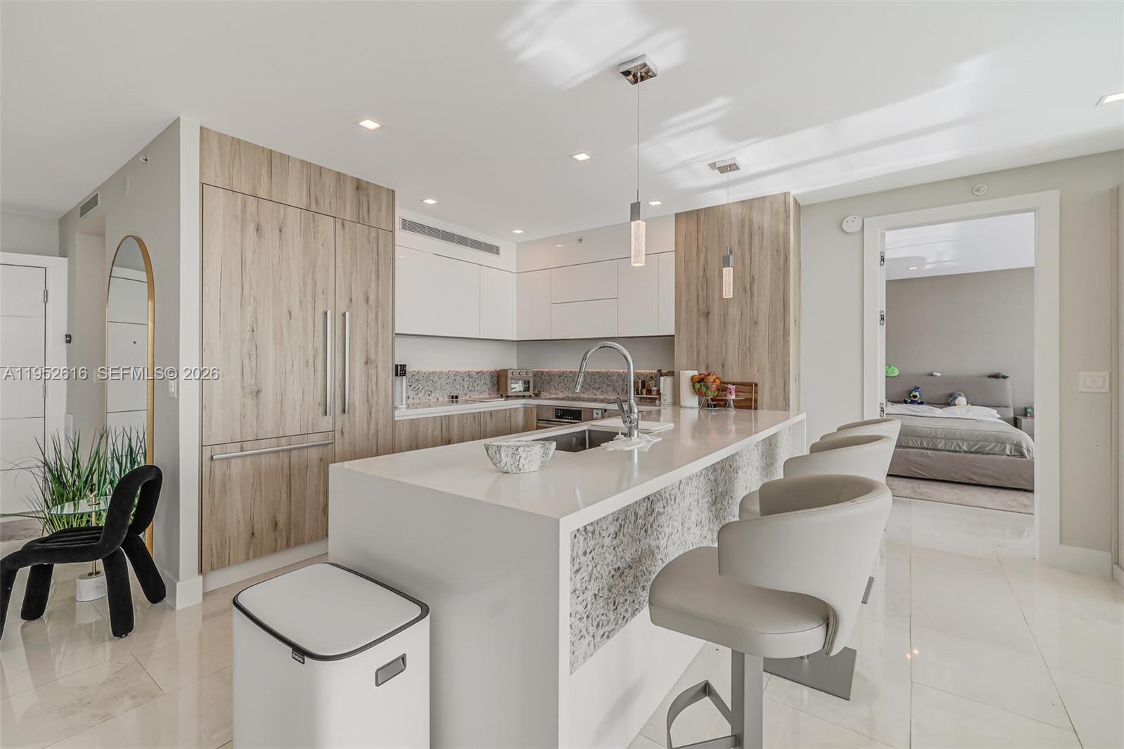 3400 Southwest 27th Avenue, Unit 802 Miami, FL 33133 - Photo 5 of 19 a large white kitchen with a sink and a refrigerator