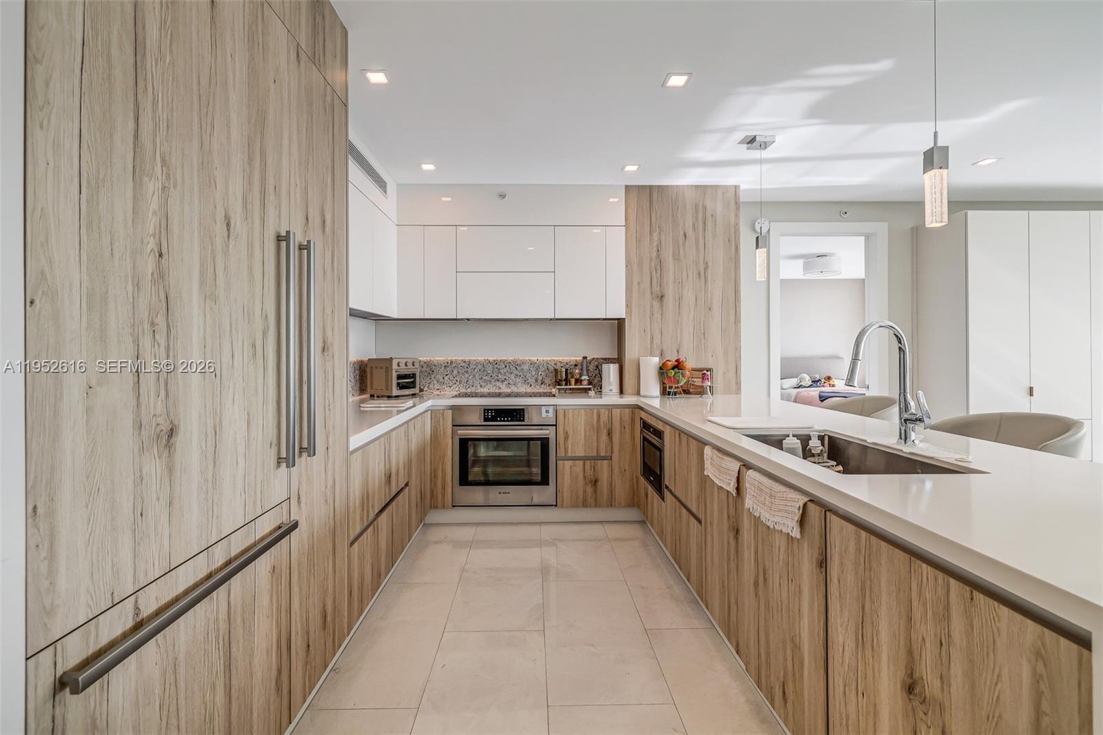3400 Southwest 27th Avenue, Unit 802 Miami, FL 33133 - Photo 6 of 19 a kitchen with stainless steel appliances a sink stove and cabinets