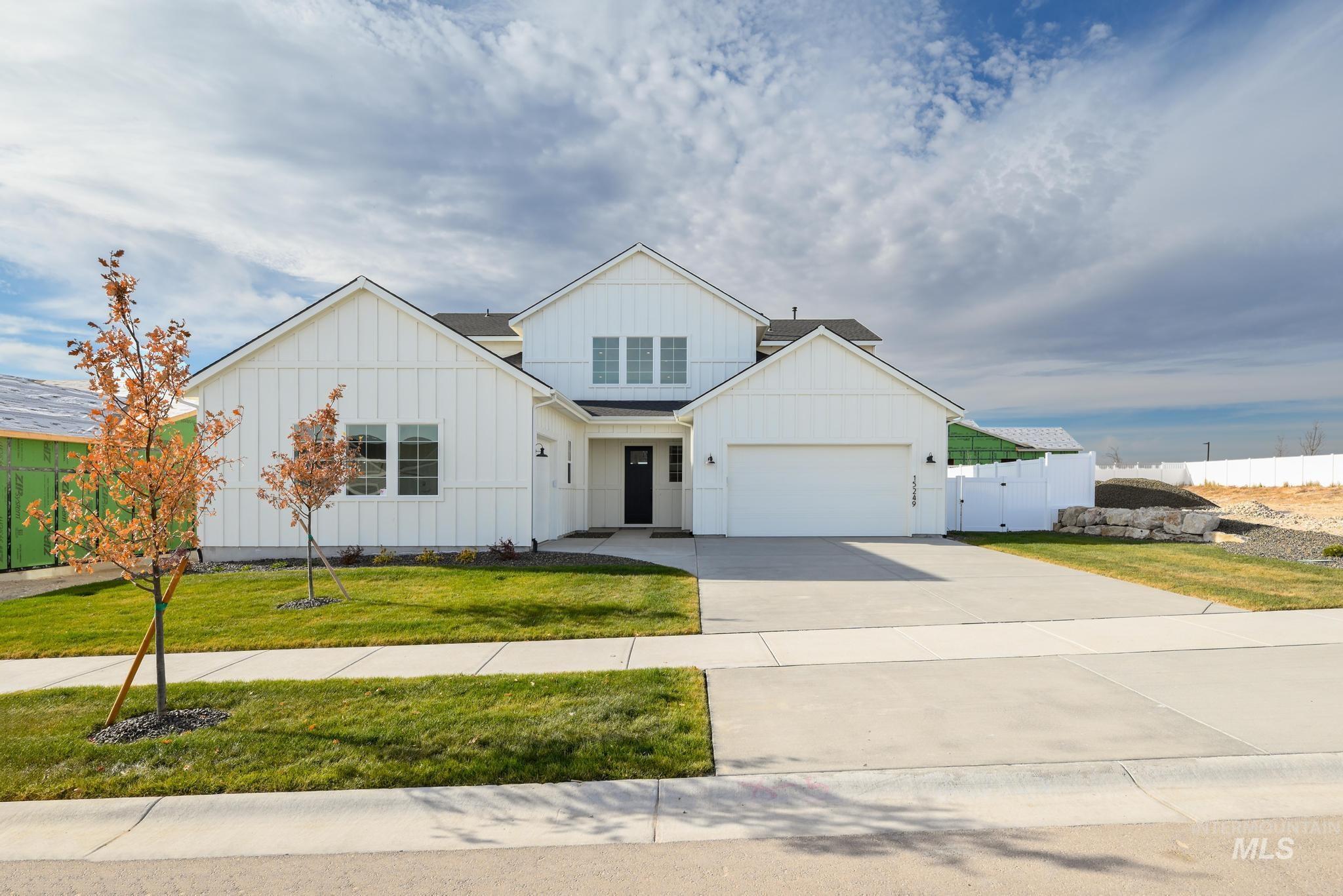 15249 Steel Cloud Avenue Caldwell, ID 83607 - Photo 2 of 46 Modern farmhouse style home featuring board and batten siding, driveway, and a gate
