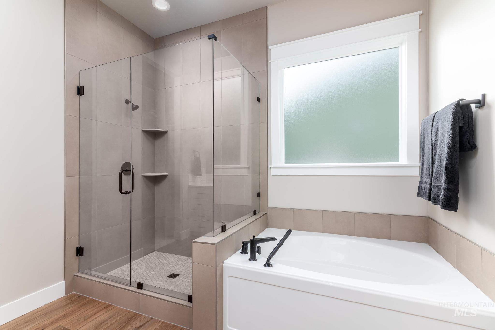 15249 Steel Cloud Avenue Caldwell, ID 83607 - Photo 24 of 46 Full bathroom featuring a garden tub and a stall shower