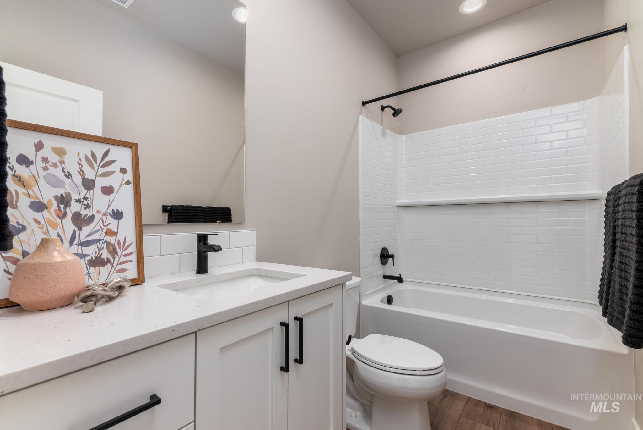 15249 Steel Cloud Avenue Caldwell, ID 83607 - Photo 28 of 46 Full bathroom featuring vanity, washtub / shower combination, light wood finished floors, and recessed lighting