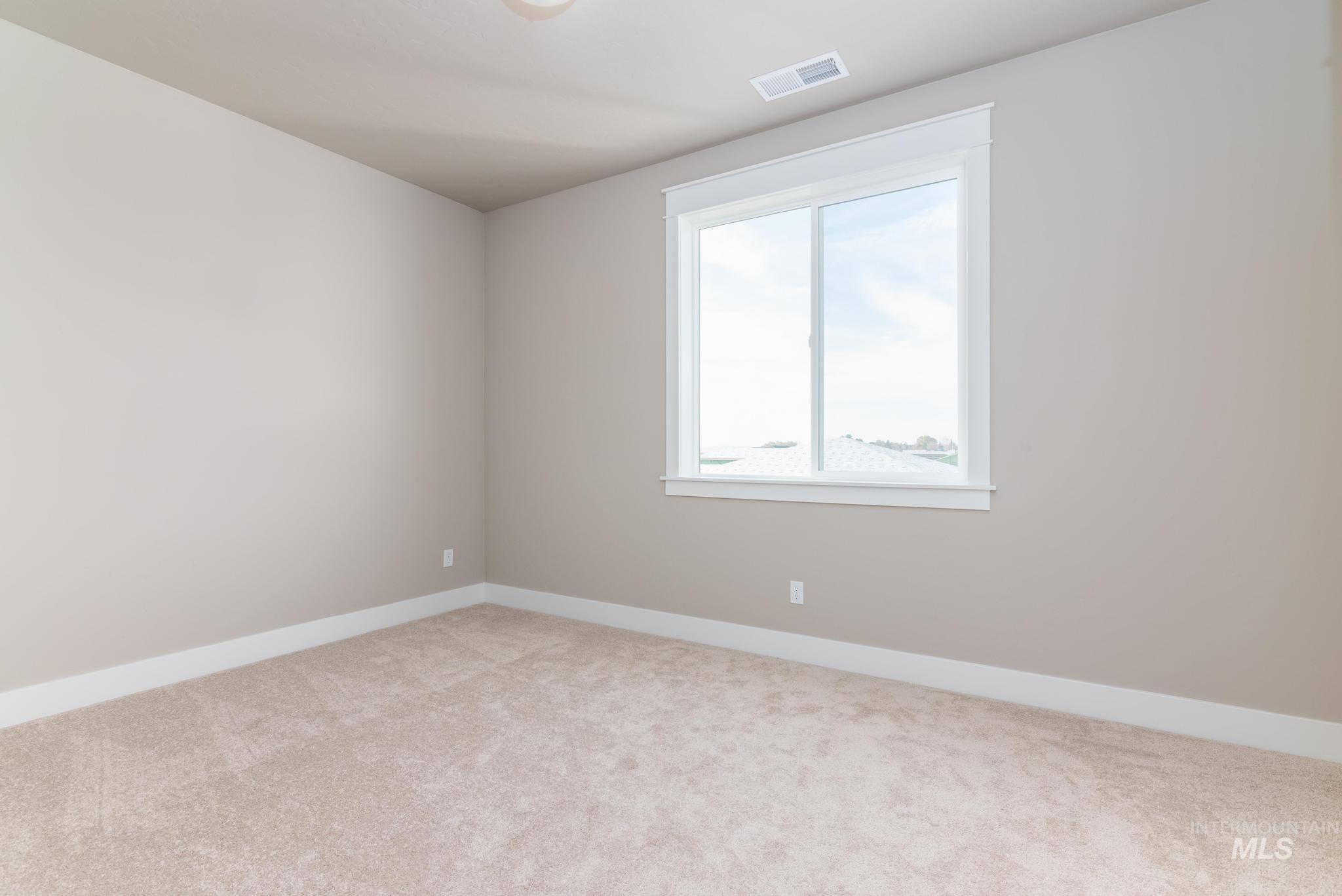 15249 Steel Cloud Avenue Caldwell, ID 83607 - Photo 29 of 46 Unfurnished room with baseboards and light carpet