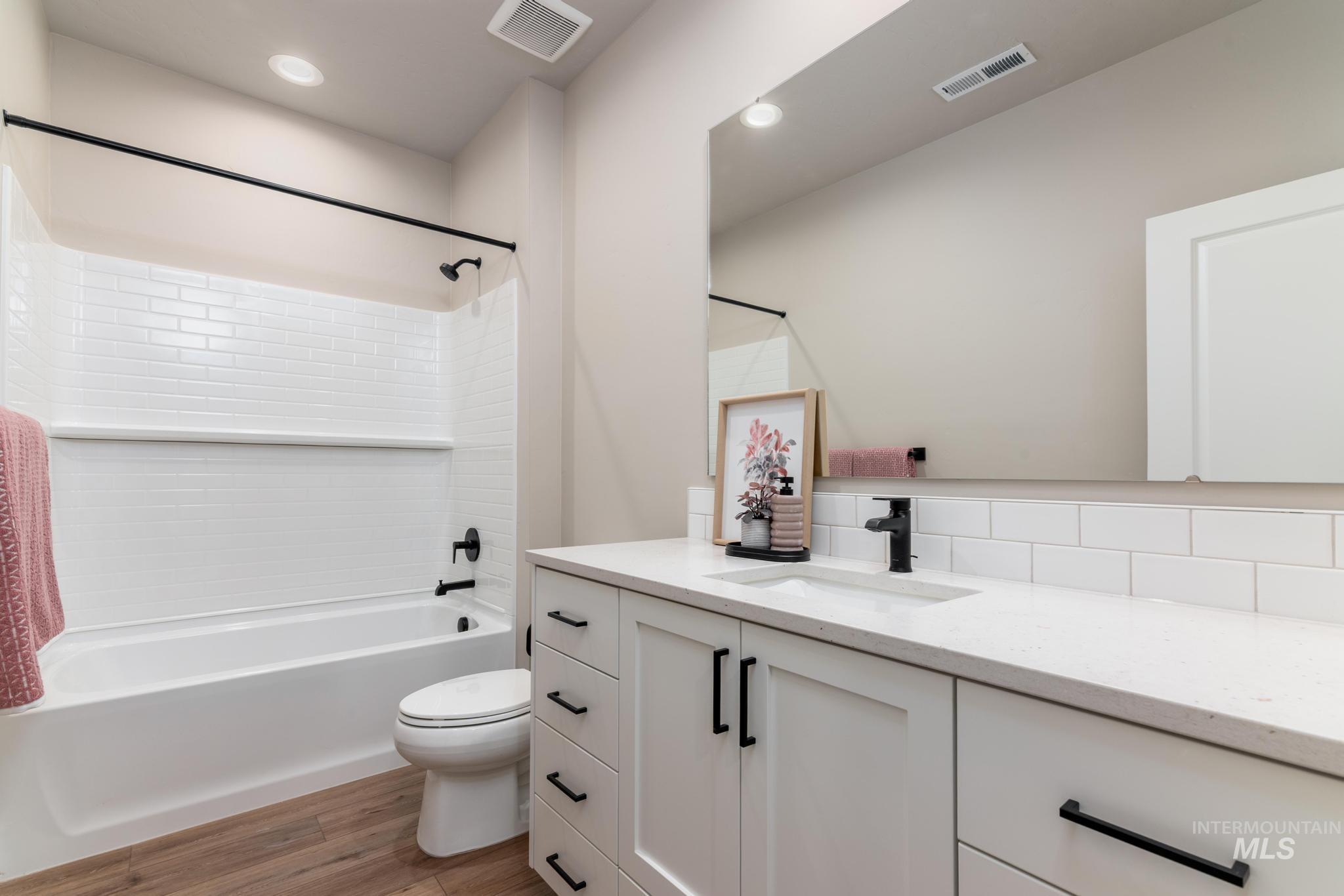 15249 Steel Cloud Avenue Caldwell, ID 83607 - Photo 30 of 46 Bathroom featuring tub / shower combination, vanity, light wood finished floors, and recessed lighting