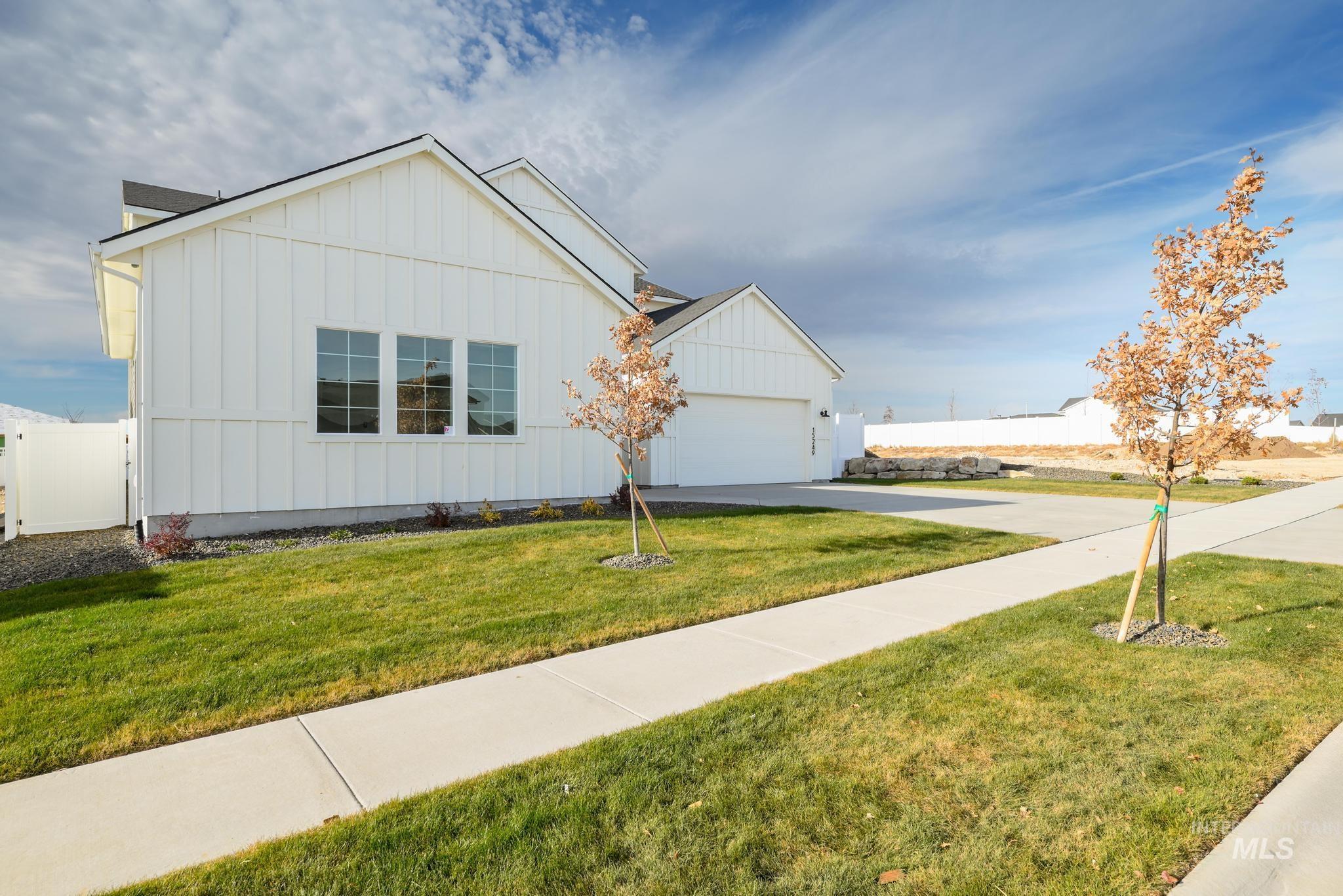 15249 Steel Cloud Avenue Caldwell, ID 83607 - Photo 3 of 46 View of front of property with board and batten siding, driveway, and an attached garage