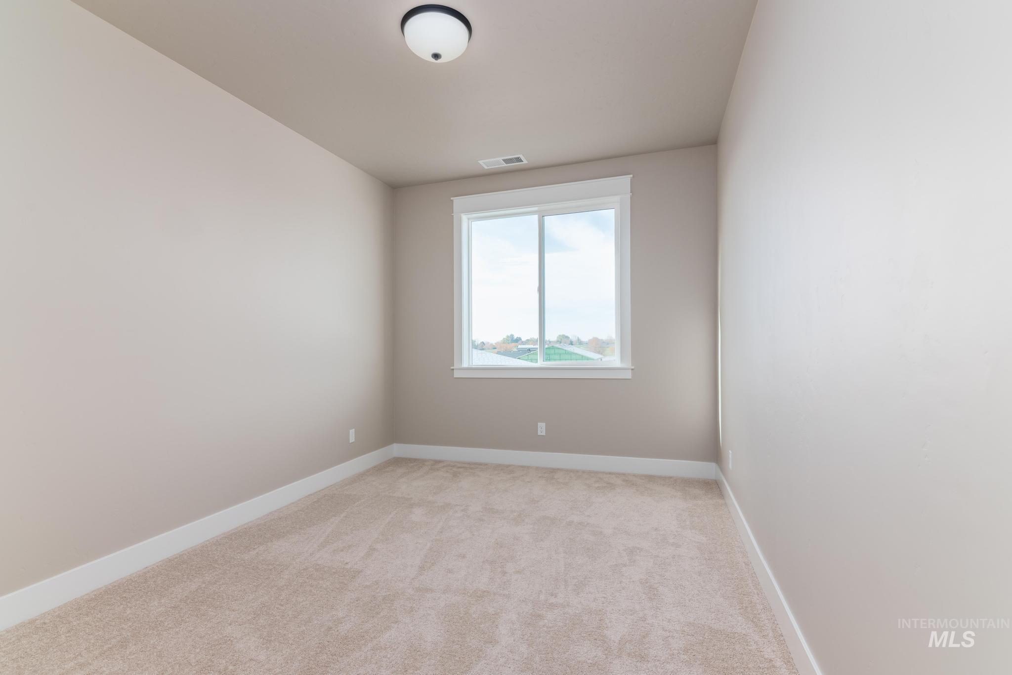 15249 Steel Cloud Avenue Caldwell, ID 83607 - Photo 31 of 46 Spare room featuring baseboards and light carpet