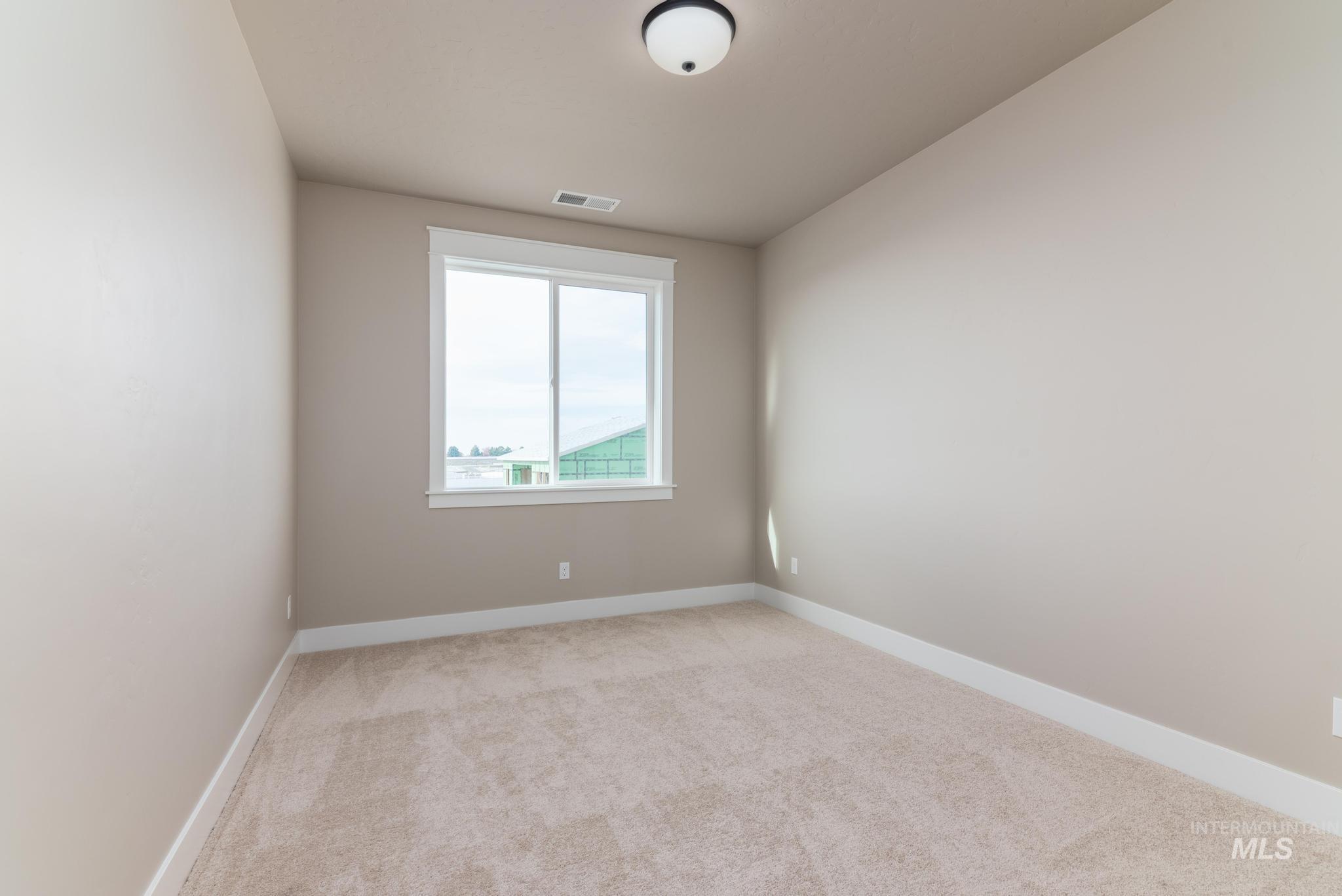 15249 Steel Cloud Avenue Caldwell, ID 83607 - Photo 32 of 46 Spare room featuring baseboards and light carpet