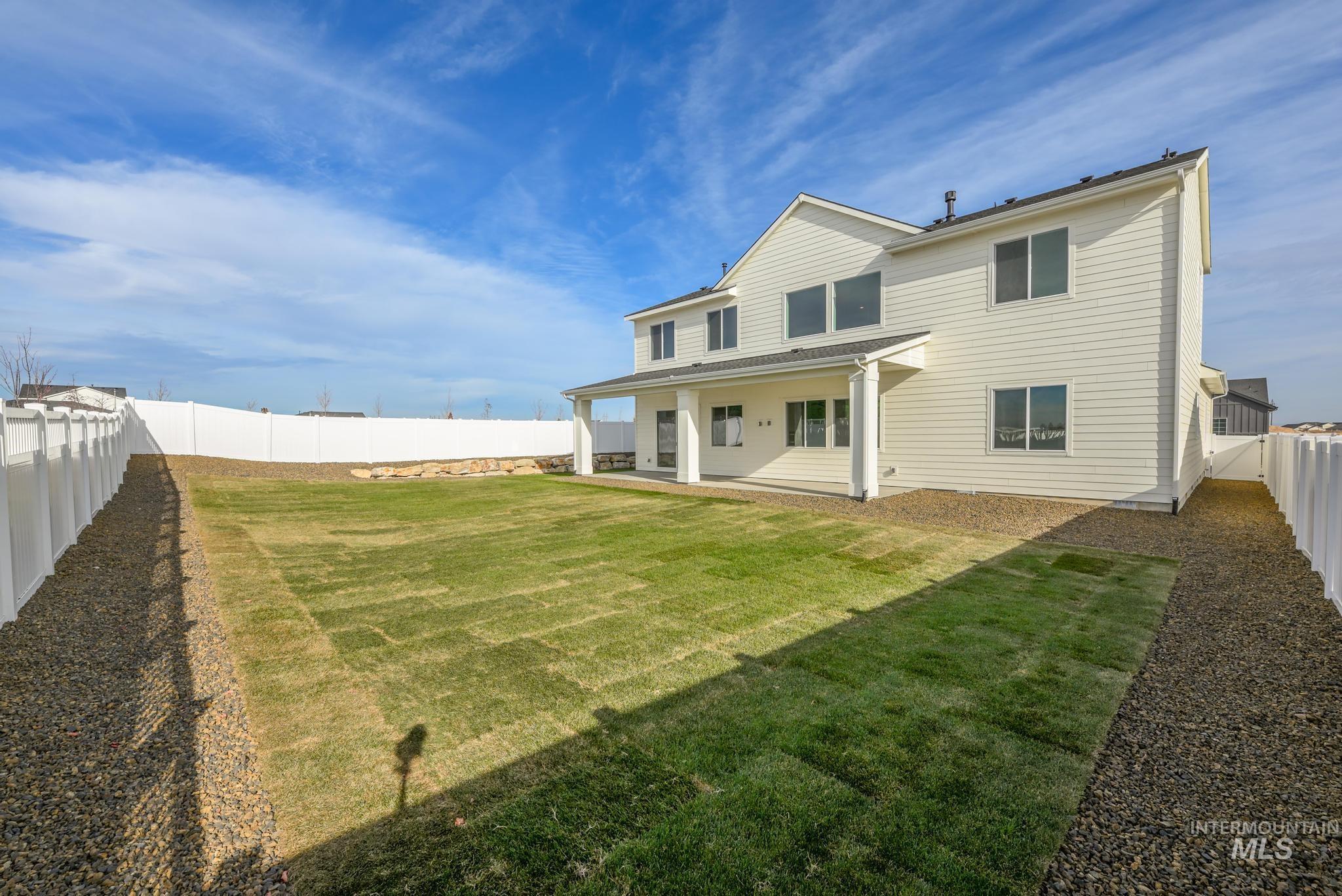 15249 Steel Cloud Avenue Caldwell, ID 83607 - Photo 34 of 46 Back of property featuring a fenced backyard and a patio