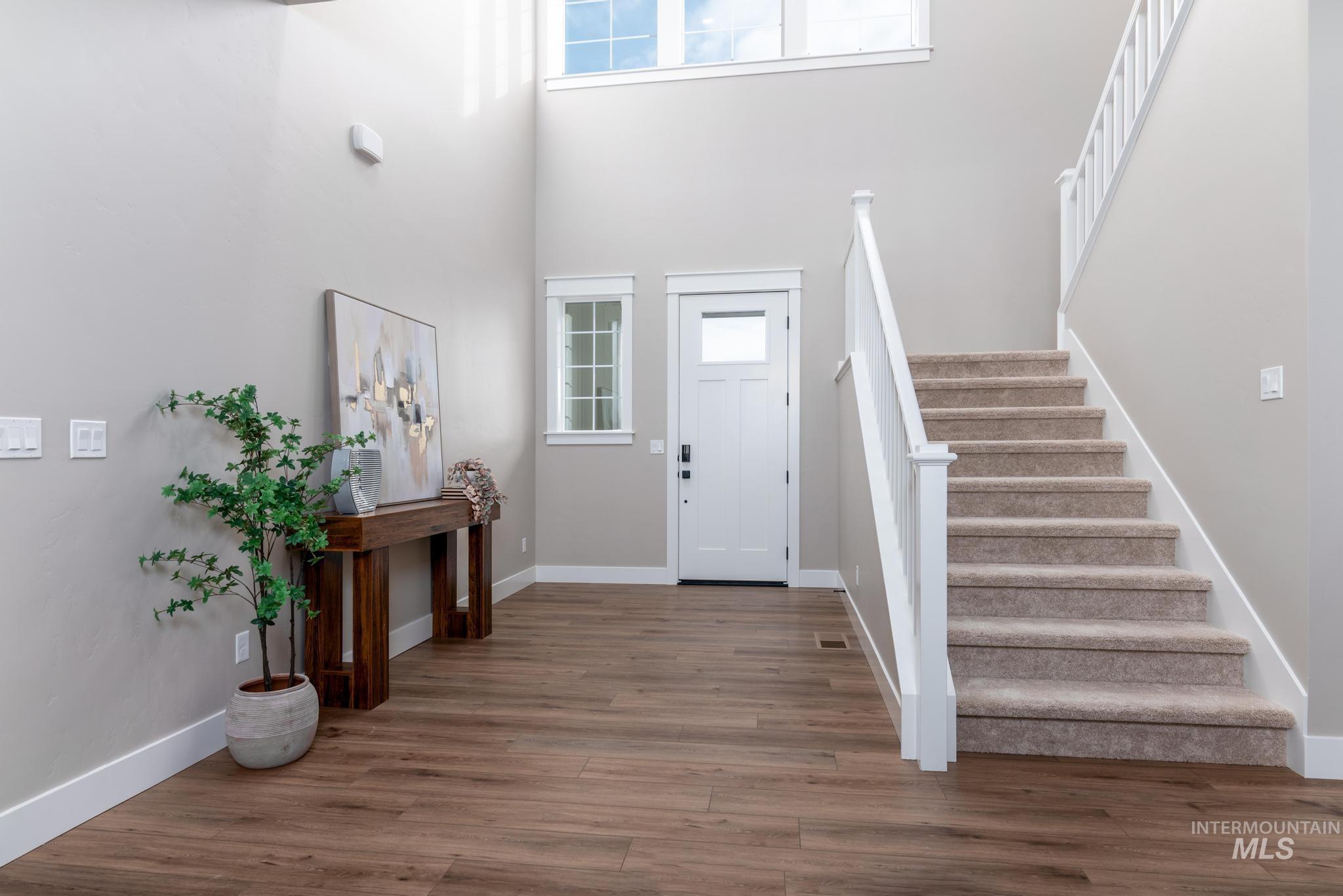 15249 Steel Cloud Avenue Caldwell, ID 83607 - Photo 4 of 46 Entrance foyer with a high ceiling, stairway, and wood finished floors