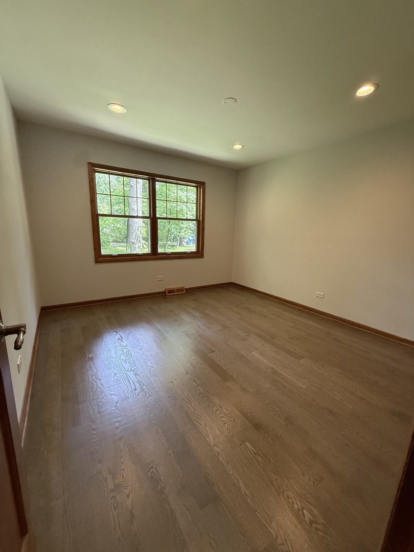 2841 Orange Brace Road Deerfield, IL 60015 - Photo 16 of 30 an empty room with wooden floor and windows