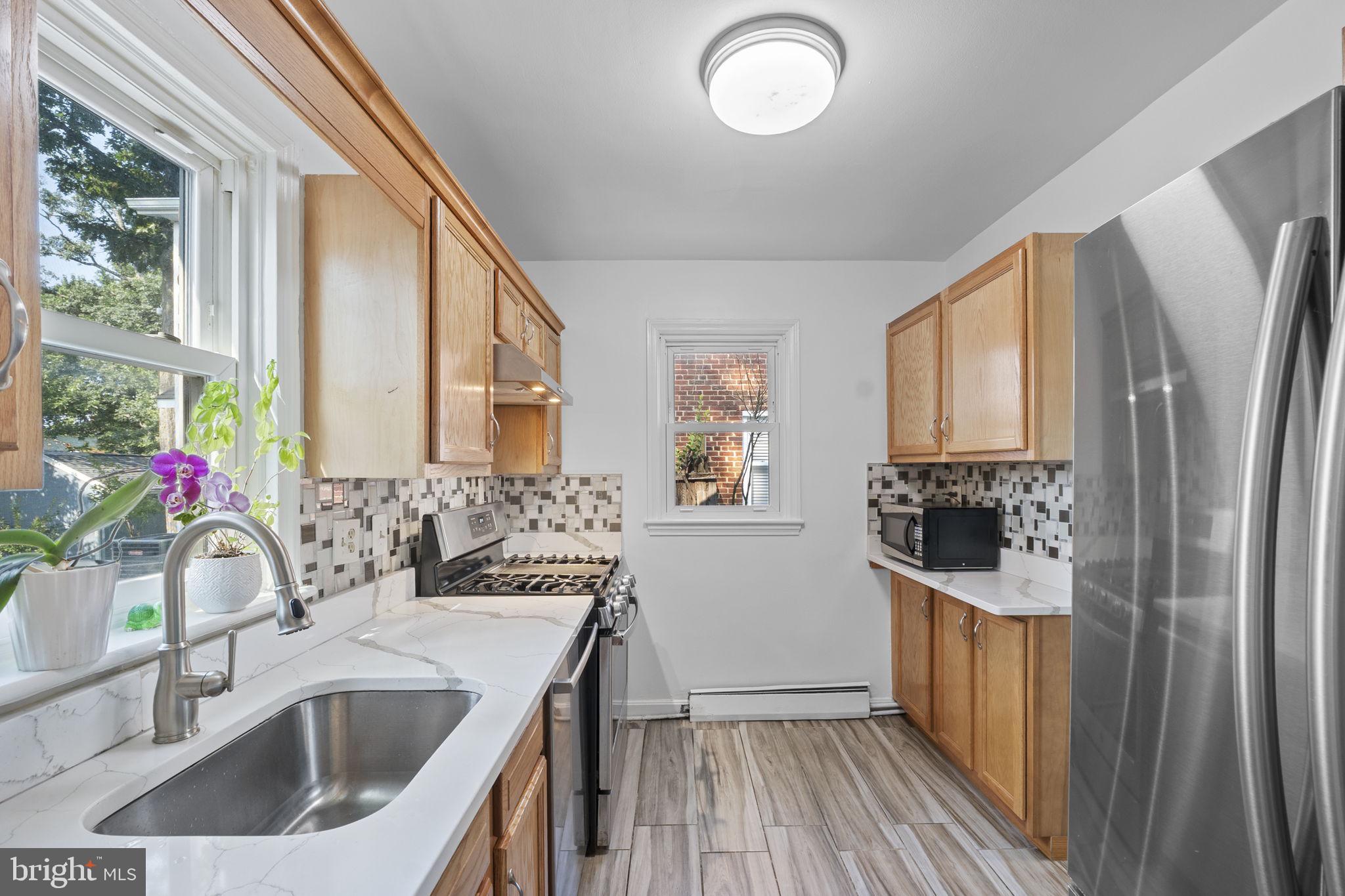 1005 Navahoe Drive Silver Spring, MD 20903 - Photo 14 of 34 a kitchen with a sink stove and refrigerator