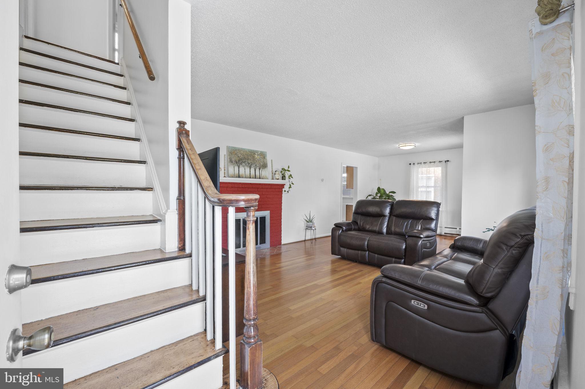 1005 Navahoe Drive Silver Spring, MD 20903 - Photo 16 of 34 a living room with furniture and a wooden floor