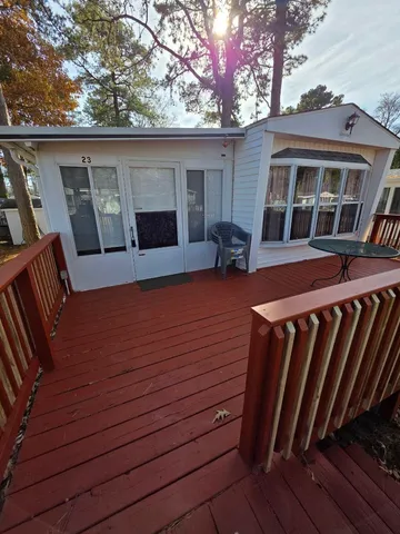 a view of backyard with deck and wooden floor