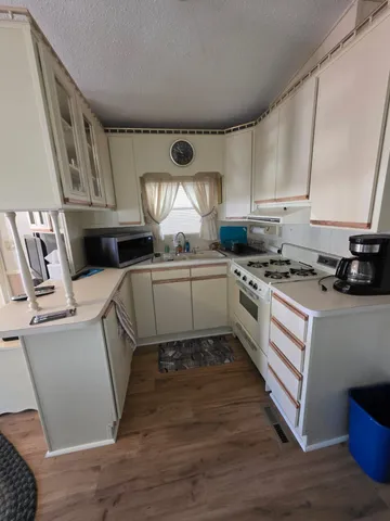 a kitchen with cabinets a sink and a stove