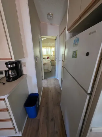 a view of a hallway and wooden floor