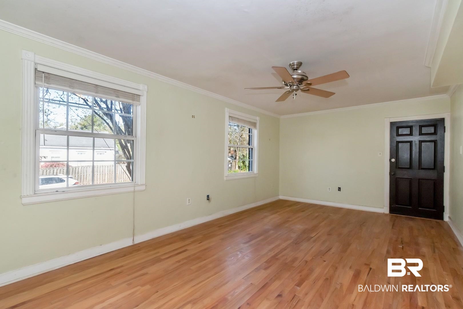 214 Upham Street, Unit 4A Mobile, AL 36607 - Photo 11 of 23 Empty room with ceiling fan, baseboards, light wood-style floors, and ornamental molding